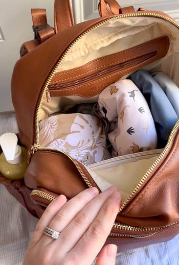  patterned blankets, babe  clothes, and a bottle