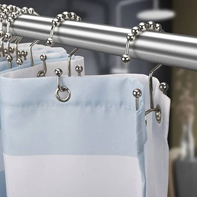 shower hooks holding up a shower curtain