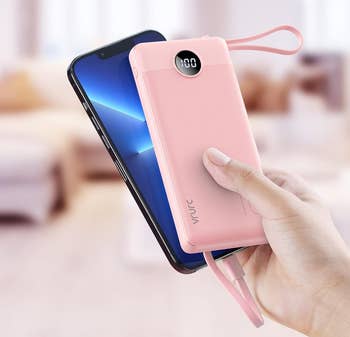 person holding the charger in pink