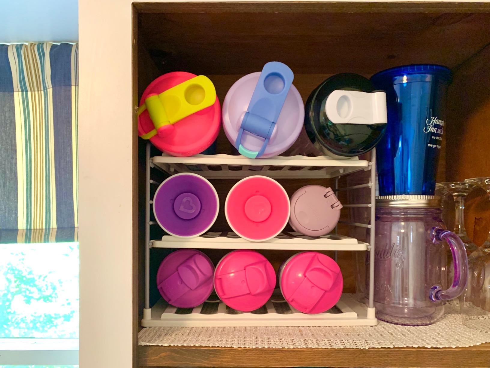 Reviewer's photo of kids' water bottle organized on the rack
