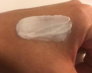 A manus with a swipe of creamy skincare merchandise connected the back