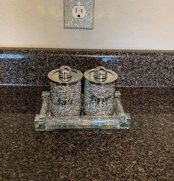 reviewer's rhinestone outlet cover above a counter 