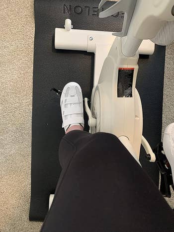reviewer wearing cycling shoes on exercise bike