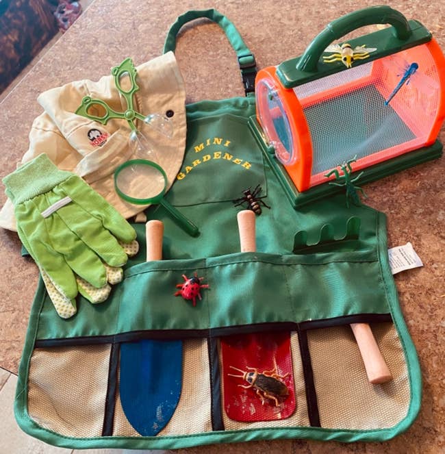 reviewer image of the complete kid's gardening tool set atop the apron