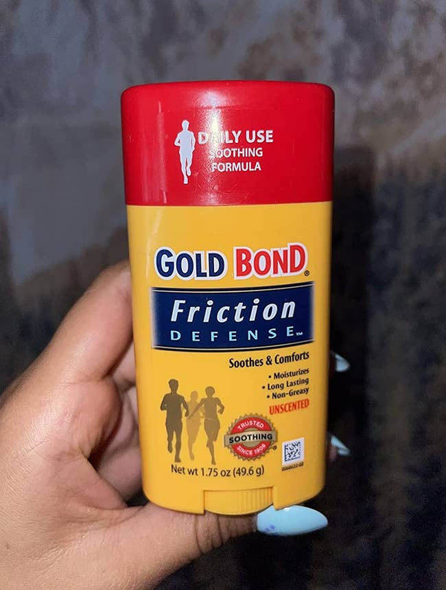a reviewer photo of a hand holding up the gold bond friction defense stick