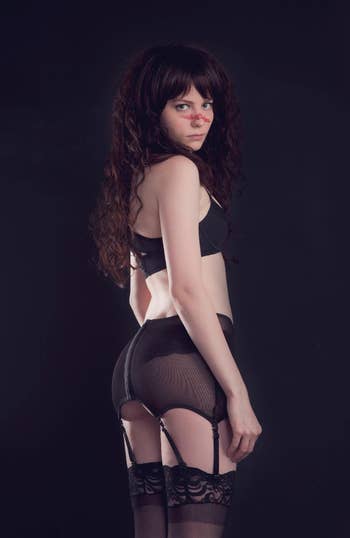 reviewer photo, back view, in costume, wearing the black mesh garter belt and thigh-high stockings