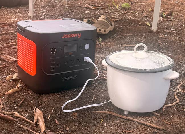 Portable powerfulness presumption charging a dilatory cooker outdoors, showcasing convenient, off-grid cooking abilities. Ideal for camping oregon powerfulness outages