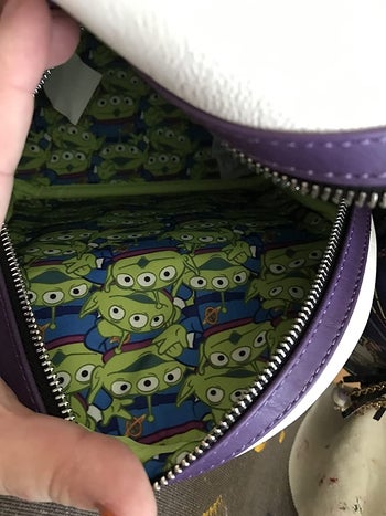 reviewer image of the inside print of the bag featuring green aliens