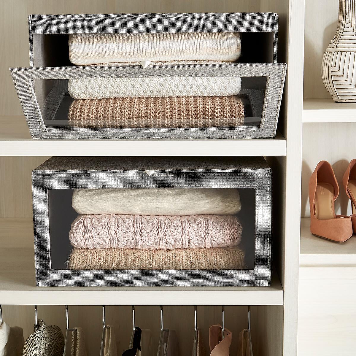 two drop-front boxes containing folded sweaters