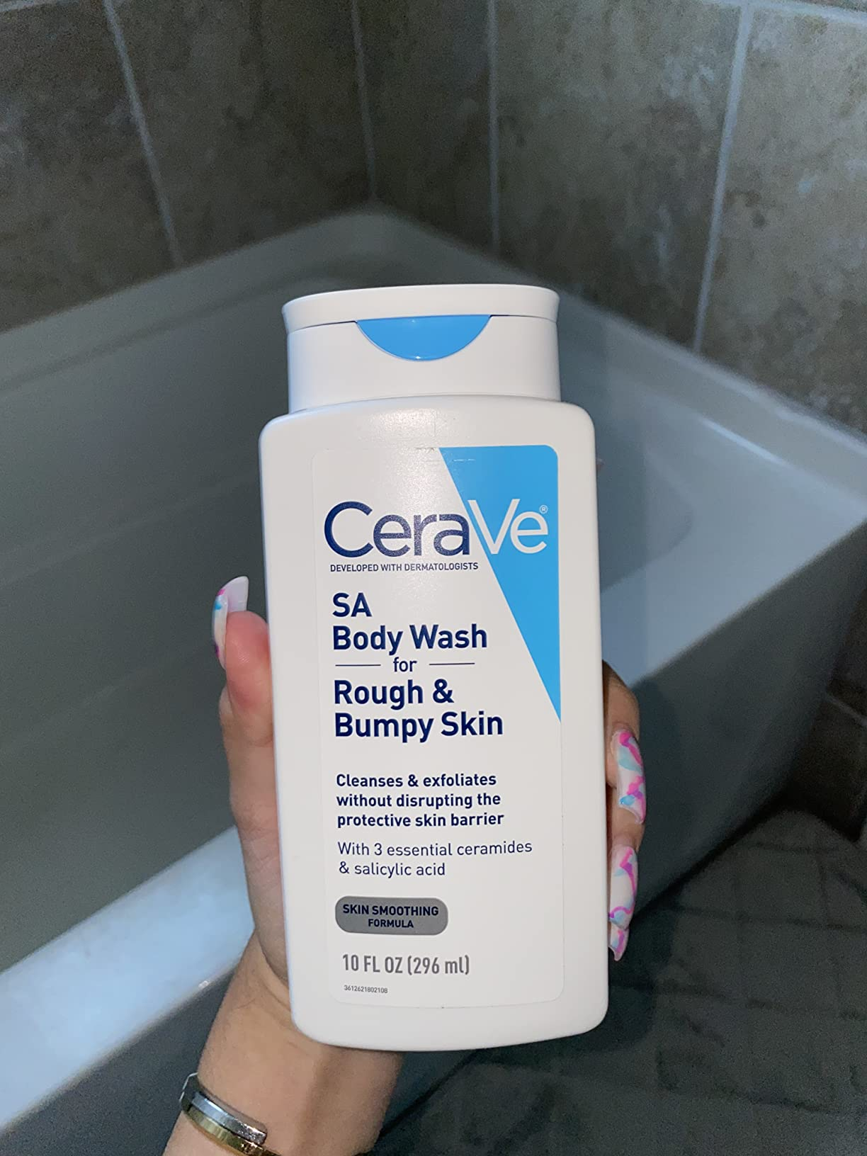 Person holding CeraVe SA Body Wash for rough, bumpy skin