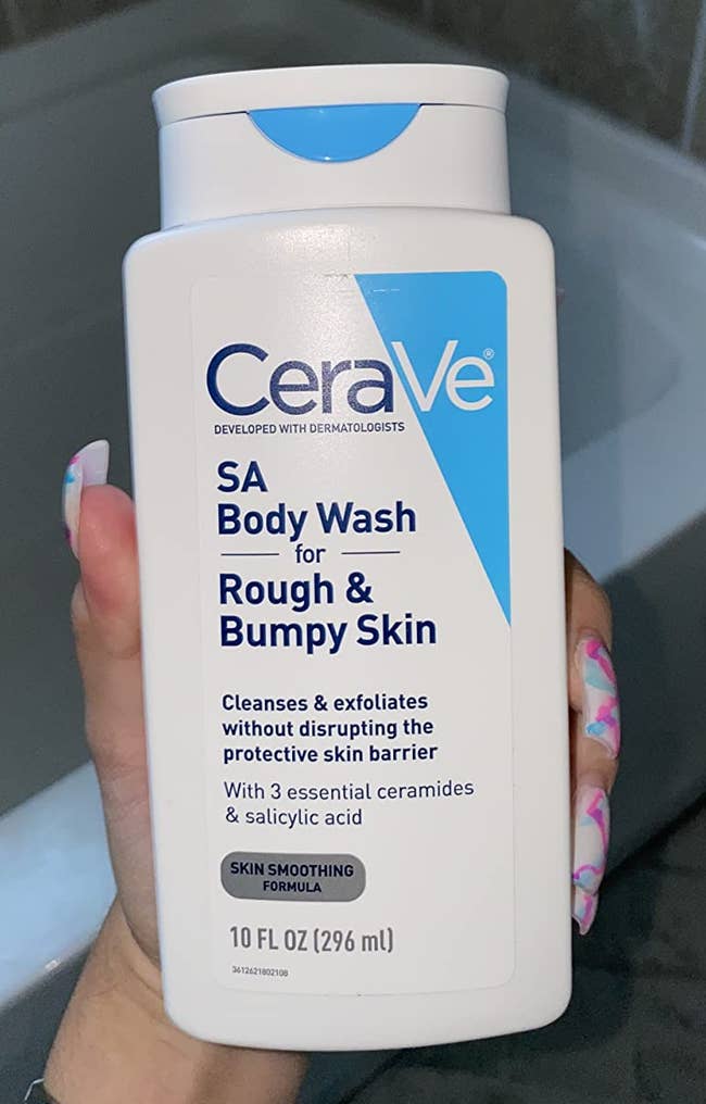 Person holding CeraVe SA Body Wash for rough, bumpy skin