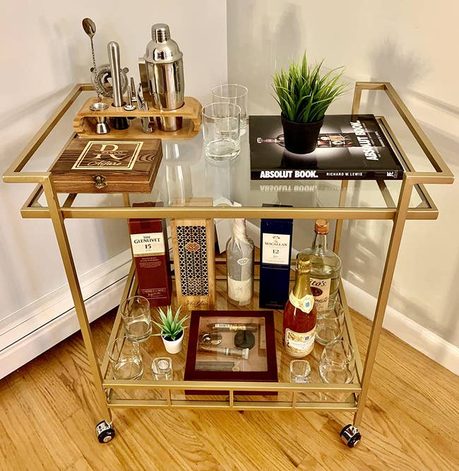 reviewer image of the gold bar cart with libations on each of its two tiers