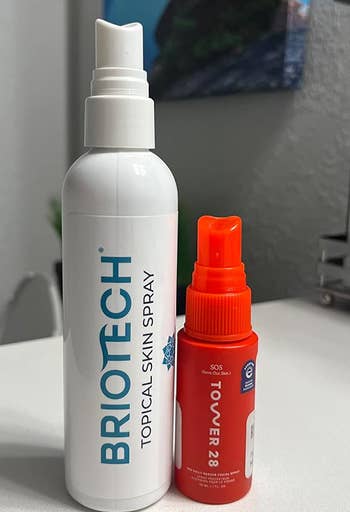 the bottle of briotech spray next to the tower 28 spray