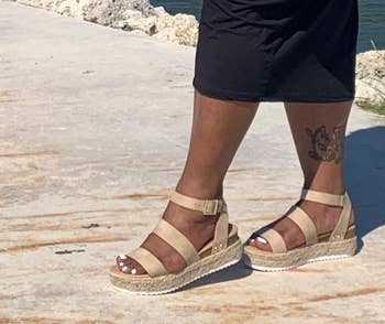 reviewer wearing the taupe platform sandals