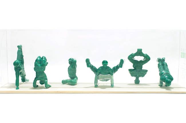 army men toys in yoga poses