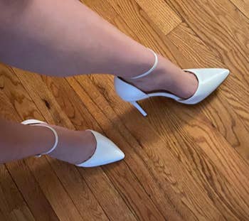 Image of reviewer wearing the white heels