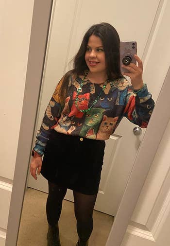 reviewer in the cat print graphic sweater