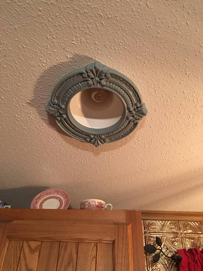 The medallion on a ceiling around a light bulb 