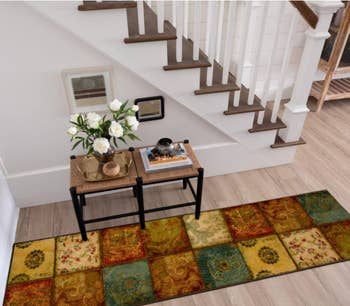 Image of the patchwork boho runner next to a staircase