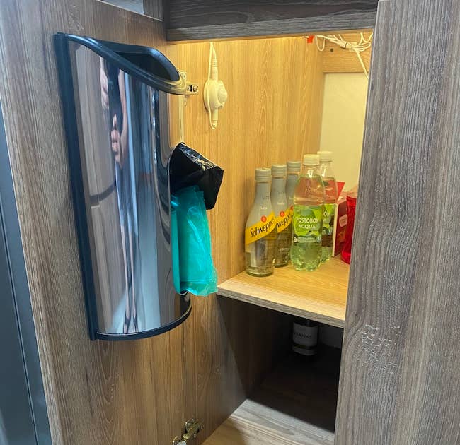 reviewer photo of the bag dispenser inside of cabinet