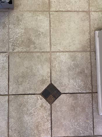 Close-up of a tiled level  with a decorative diamond-shaped accent tile successful  the center