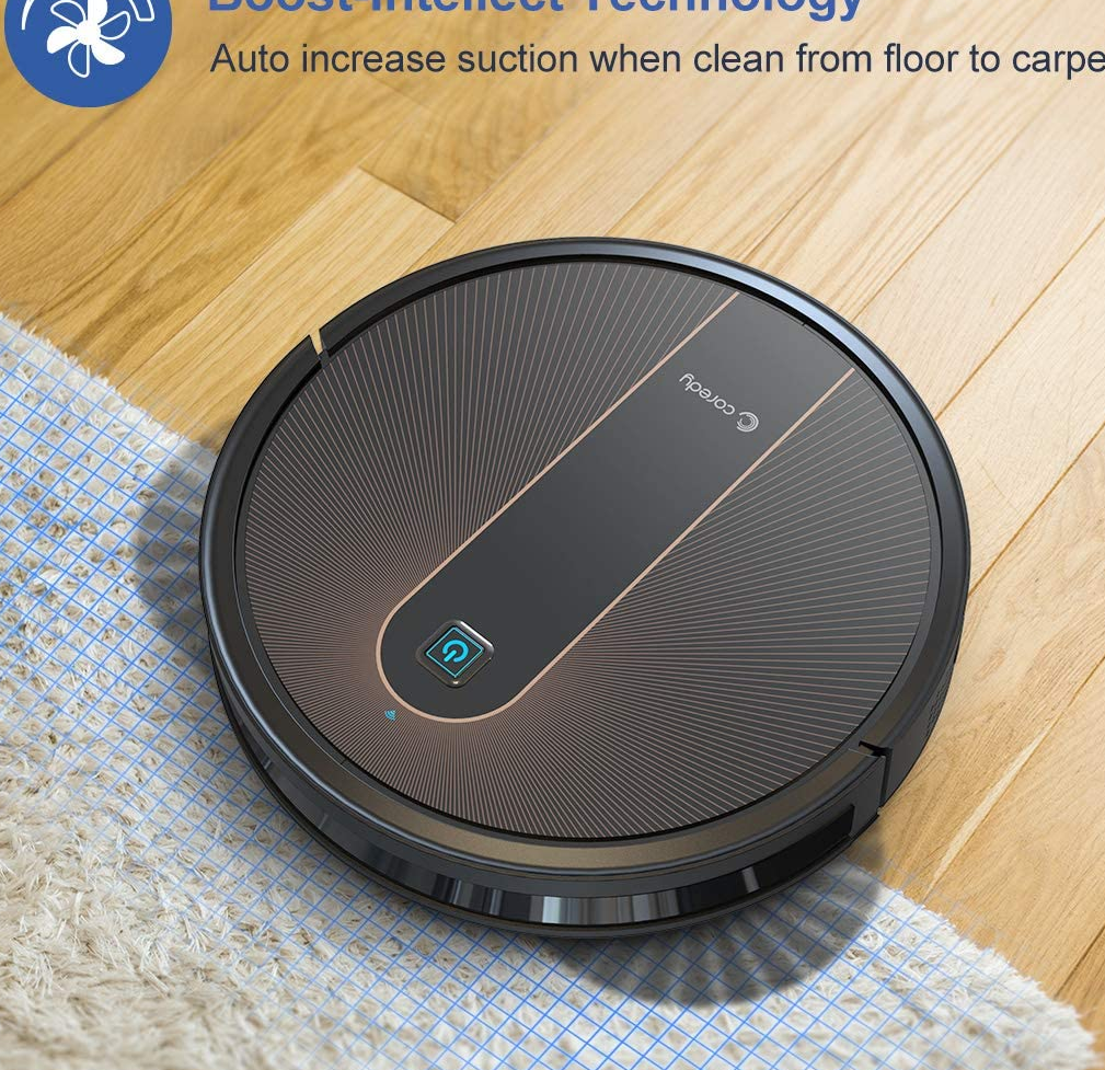 the black robot vacuum going over a rug