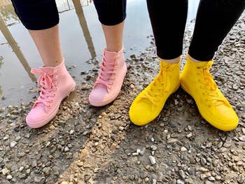 Reviewers wearing pinkish  and yellowish  rainfall  sneakers