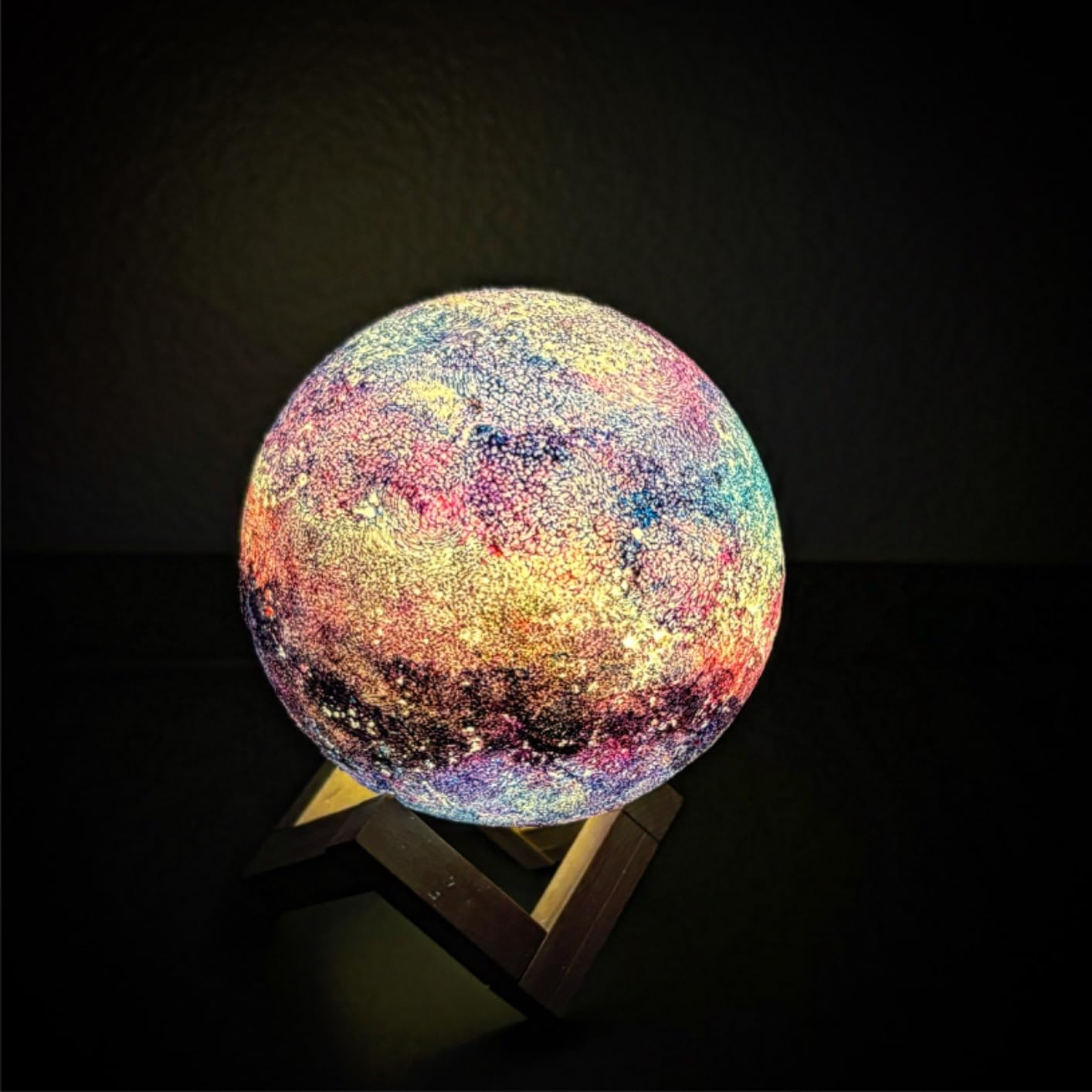 Textured spherical lamp on a stand, displaying a galaxy pattern. Suitable for home decor or as a nightlight