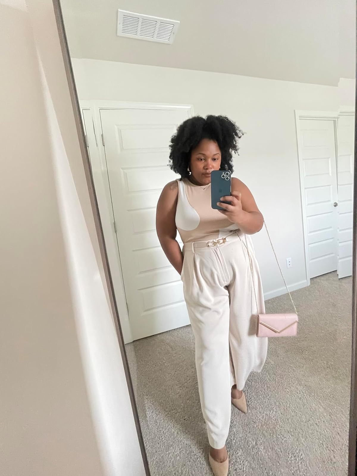 reviewer wearing the achromatic  pants with a achromatic  tank