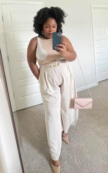 reviewer wearing the achromatic pants with a achromatic tank