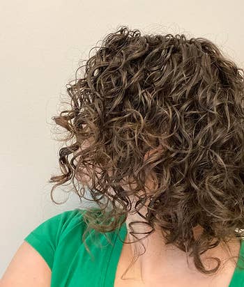 reviewer with healthy looking curly wavy hair