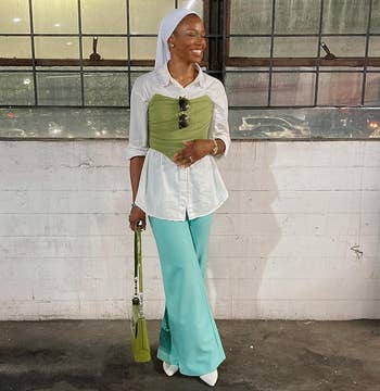 reviewer wearing the green corset top over a white button-down