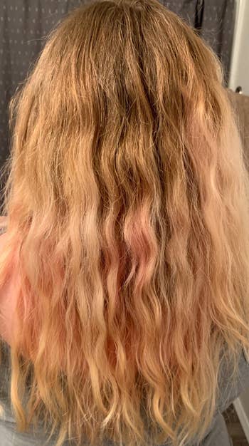 reviewer showing their curls more defined and with more volume after using conditioner