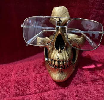 A gold skull with a reviewer's glasses displayed on it