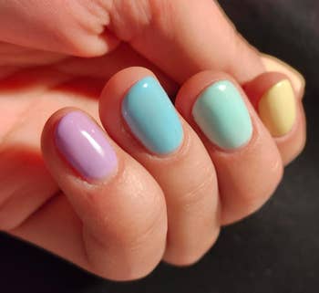 reviewer with multicolored pastel nails