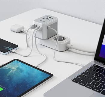 Adapter plugged into a power strip with four devices plugged in
