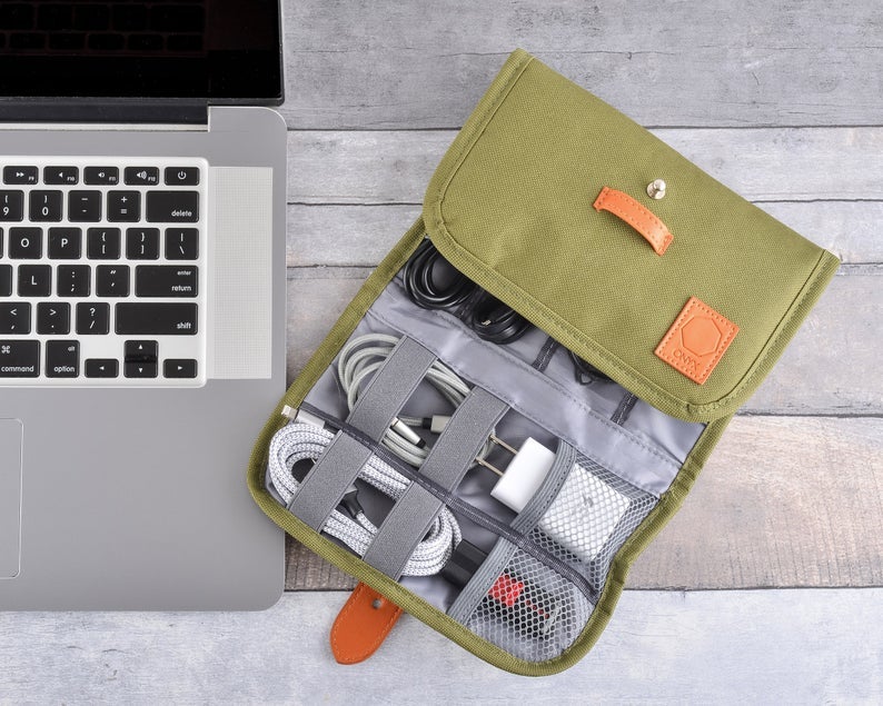 the olive green organizer with brown faux leather accents holding small tech items