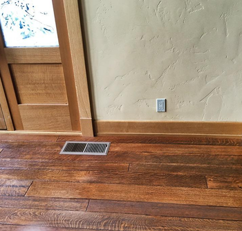 same reviewer's after photo of the wood floor looking much brighter after being polished with the conditioner