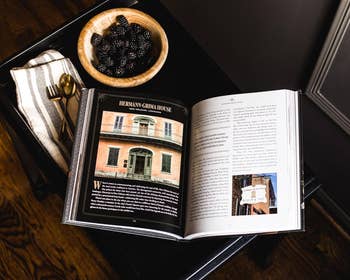 Open publication  connected  a acheronian  array  featuring a transition  connected  Hermann-Grima House, a vessel  of blackberries, and a cloth napkin with golden  utensils