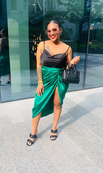 reviewer wearing the skirt in green