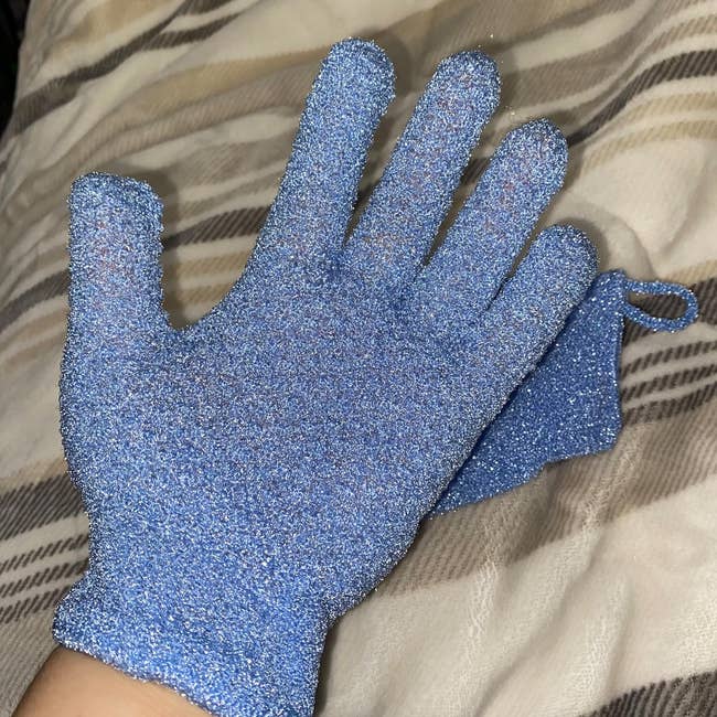 Reviewer wearing blue fingered glove