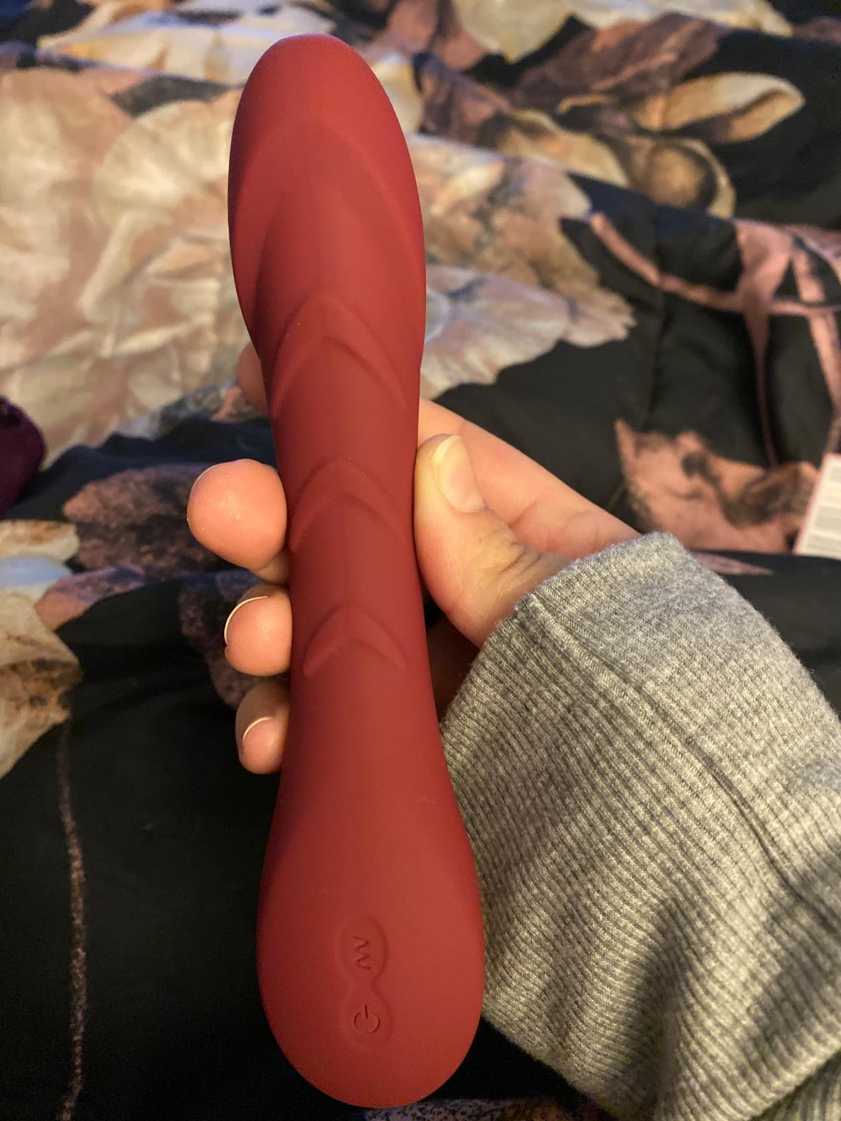 Hand holding vibrator to show textured ridges