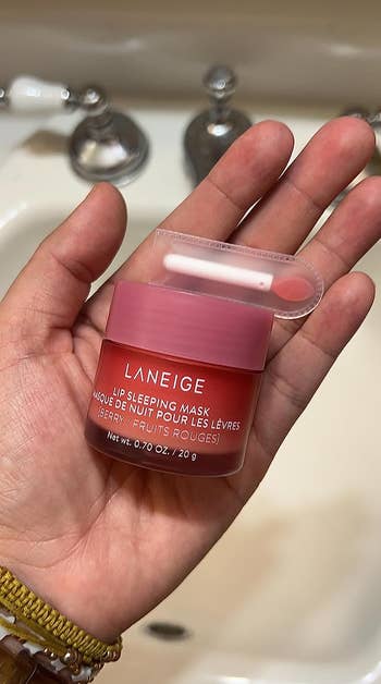 Reviewer holding the lip mask jar and applicator