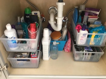 the same cabinet with the toiletries neatly stored in a two-tier cabinet