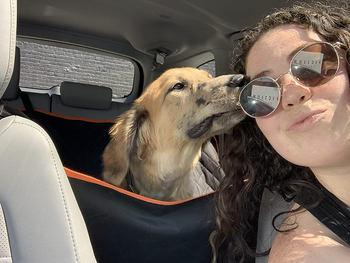 reviewer selfie with dog sitting in back of car in hammock