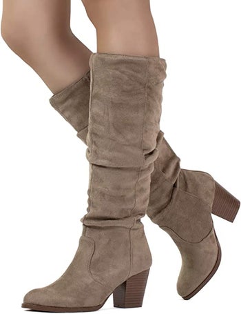 a model wearing taupe suede slouchy boots