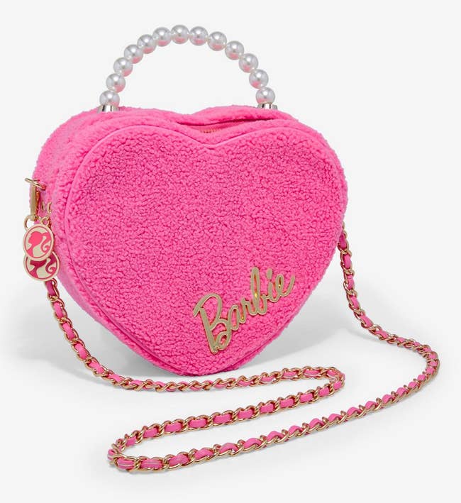 the pink bag with barbie logo zipper pulls, barbie gold text on front, pearl handle, and chain strap
