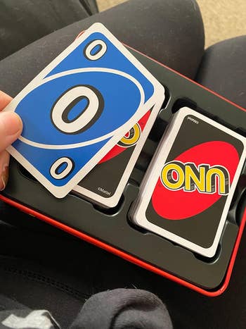 A reviewer's Uno game tin opened
