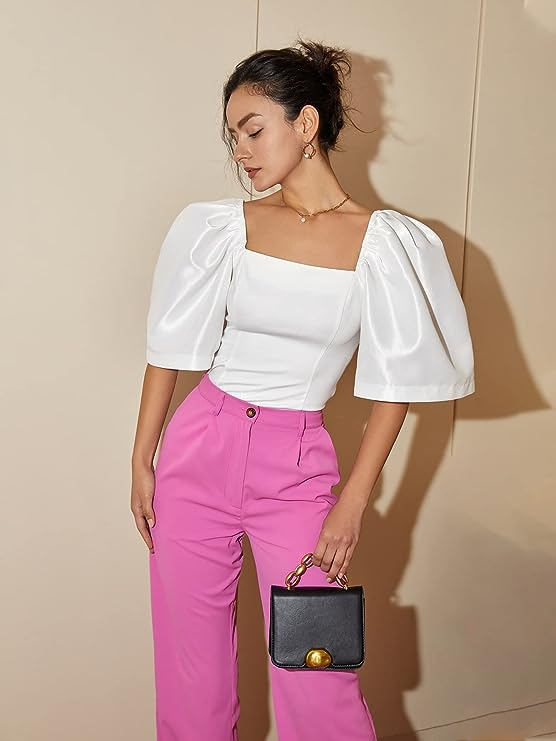 model posing in the white blouse with pink pants