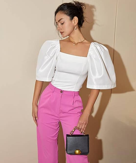 model posing in the white blouse with pink pants